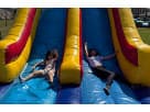 Kids Sliding down 60ft Obstacle Course Rentals
