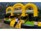 Kids in front Adrenaline toxic Obstacle Course Bounce house