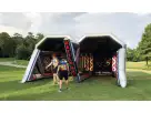 Battle Axe Blacklight inflatable axe throw game rental in Houston with glow-in-the-dark axes, ideal for Pasadena events.