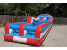 Red and blue bungee run obstacle course rental in Houston, perfect for teenagers and adults competing in The Woodlands.