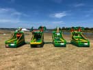 Tropical luau carnival game station rental in Austin with integrated basketball hoop, tee-ball stand, and games