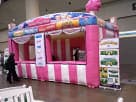 Pink and white striped Carnival Treat Shop rental in Houston with dual serving windows, ideal for Pearland events.