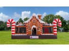 Gingerbread Wonder Playland bounce house rental in Houston with candy cane pillars and slide, ideal for Cypress holiday parties.