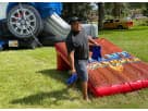 Giant inflatable cornhole game rental in Houston with 5-foot-wide boards, ideal for League City team building events.