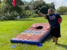 Giant cornhole game rental in Houston with 5-foot-wide boards, ideal for backyard parties and interactive events in Sugar Land.