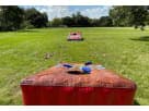 Giant inflatable cornhole rental in Houston—5 feet wide, perfect for Kingwood backyard parties and events with bean bags included.