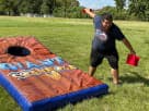 Giant cornhole game rental in Houston featuring brown and blue boards, ideal for Conroe parties and backyard events.