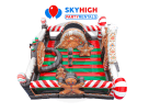 Gingerbread bounce house rental in Houston with red and green striped walls, ideal for The Woodlands holiday parties.
