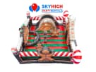 Gingerbread bounce house rental in Houston with red and green striped walls, ideal for The Woodlands holiday parties.
