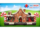 Perfect for Houston Christmas parties, this gingerbread bounce house rental features a slide and interactive popups