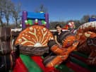 Perfect for Houston birthday parties, this gingerbread-themed bounce house rental features a slide and popup obstacles