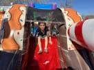 Gingerbread Wonder Playland bounce house rental in Houston with popup features and slide, ideal for Sugar Land holiday events.