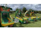 Tropical luau carnival game station rental in Austin with basketball hoop and tee-ball stand, ideal for island-themed parties